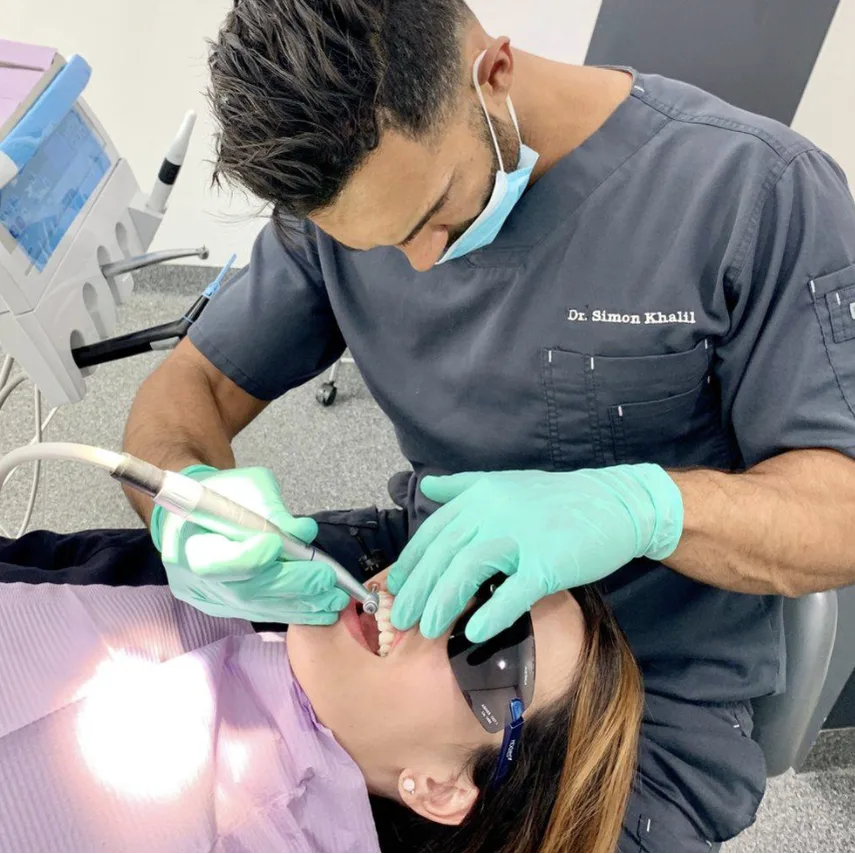 Dentist performs wisdom tooth extraction on patient in Petersham